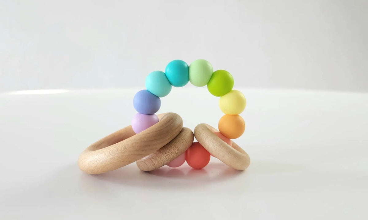 Saturn Ring Teether with rainbow silicone beads and natural wooden rings