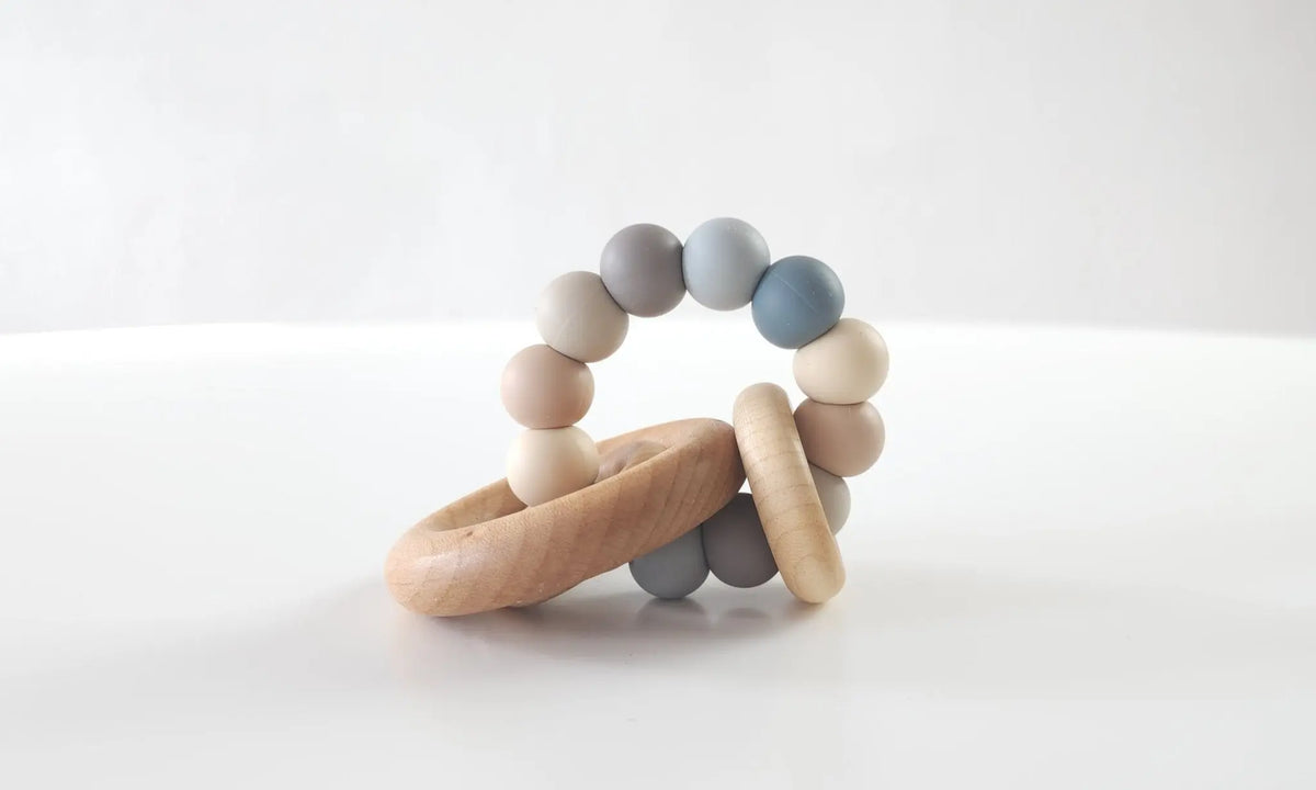 Saturn Ring Teether with gray and neutral silicone beads and wooden rings
