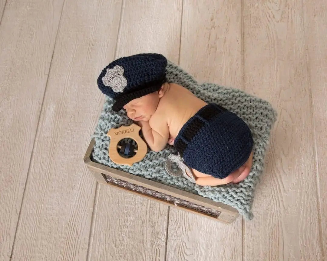 Lifestyle photo showing a wooden baby rattle with a child