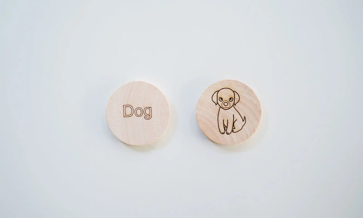 Two round wooden tiles pairing the word Dog with a dog illustration