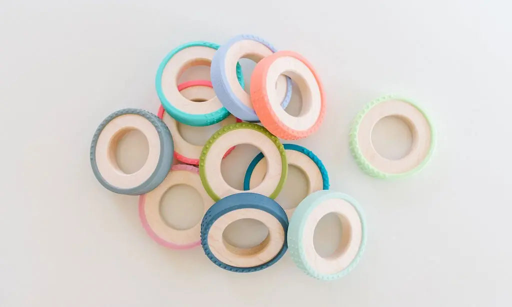 Silicone-wrapped wooden teething rings in a variety of colors