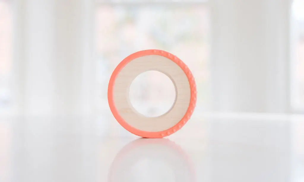 Wooden teething ring with a coral silicone wrap