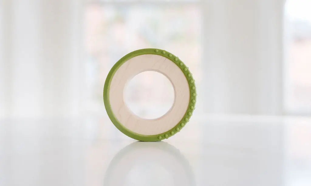Wooden teething ring with an olive-green silicone wrap