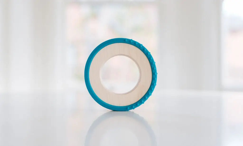 Wooden teething ring with a teal silicone wrap