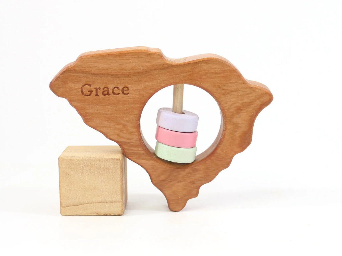 Bannor Toys South Carolina State Wooden Baby Rattle with example laser engraving and colored rattle discs