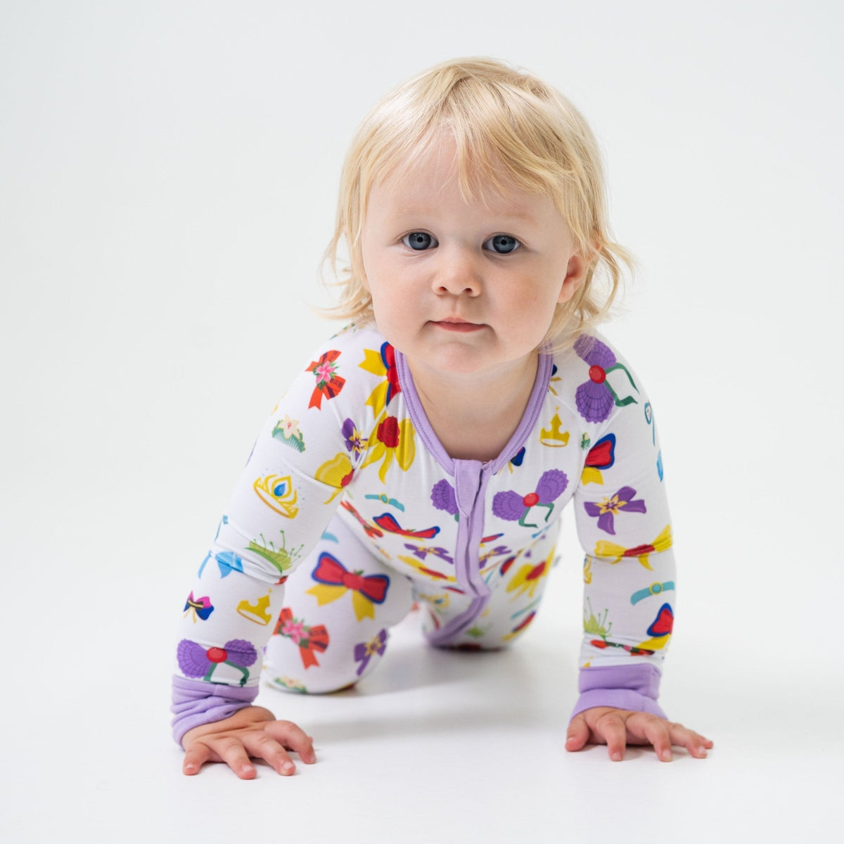 Baby on hands and knees wearing Bam & Stitch Sparkle & Reign Convertible Romper.