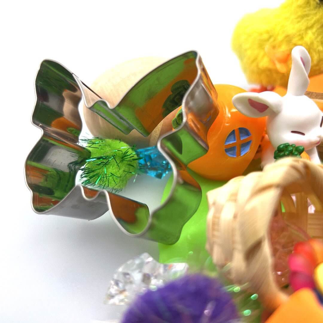 Butterfly cutter beside a bunny and chick; the pictured carrot house is not included