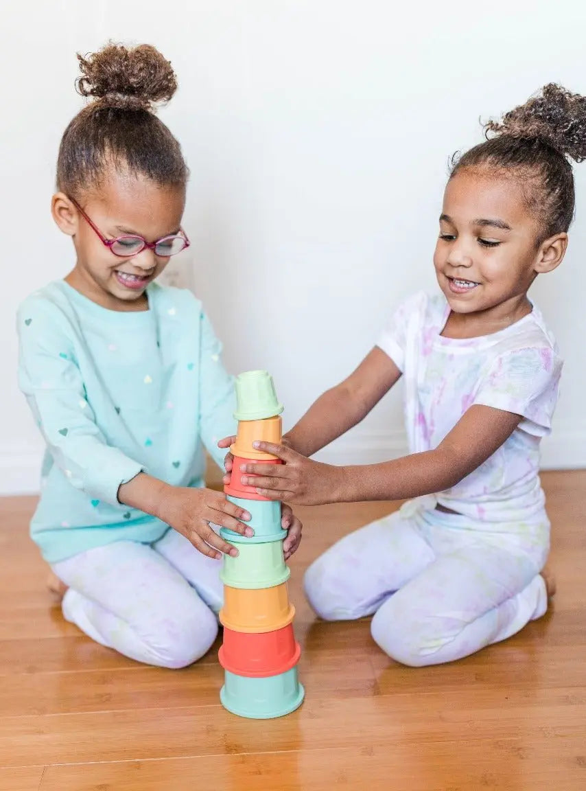 Lifestyle photo showing silicone stacking toys with a child