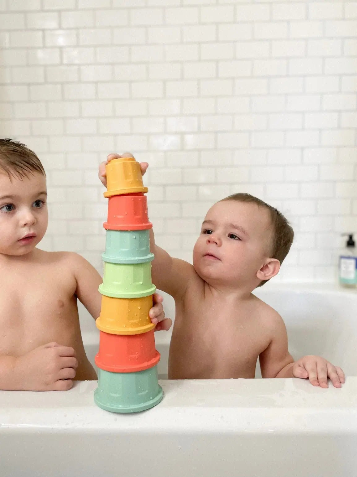 Lifestyle photo showing silicone stacking toys with a child