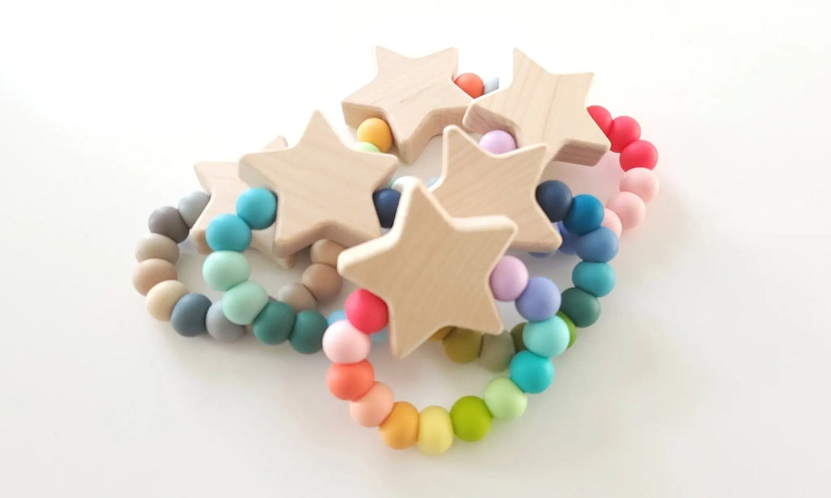 Bannor Toys Star Charm Teether collection view, showing wooden component and colored silicone