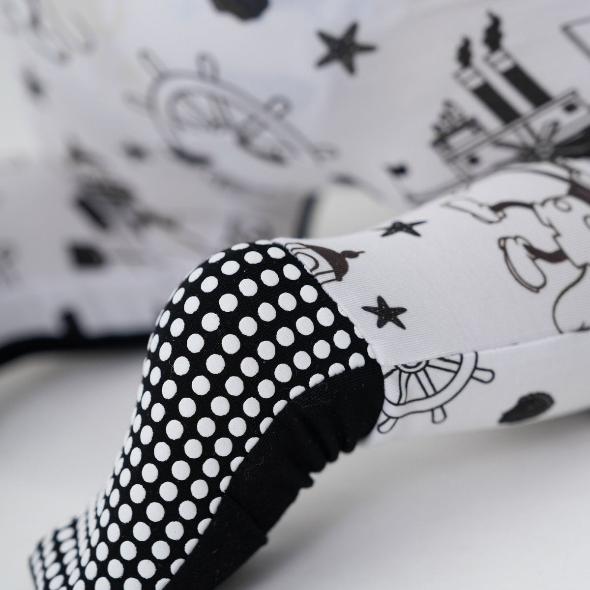 Close-up of the fold-over feet and dotted soles on Bam & Stitch Steamboat Willie Convertible Romper.