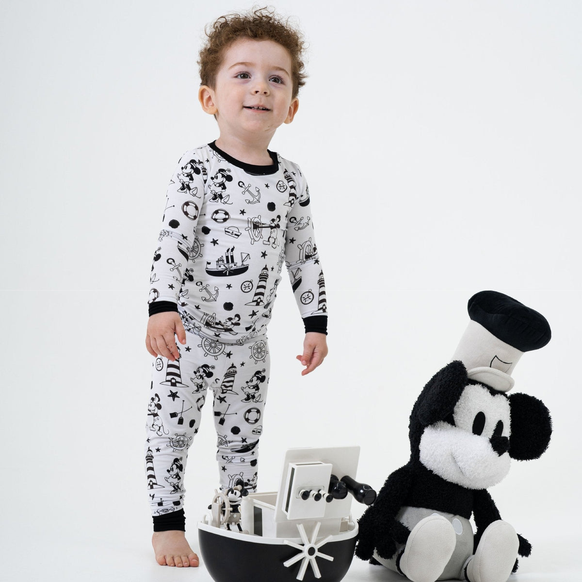 Child wearing Bam & Stitch Steamboat Willie Long Sleeve Pajamas.