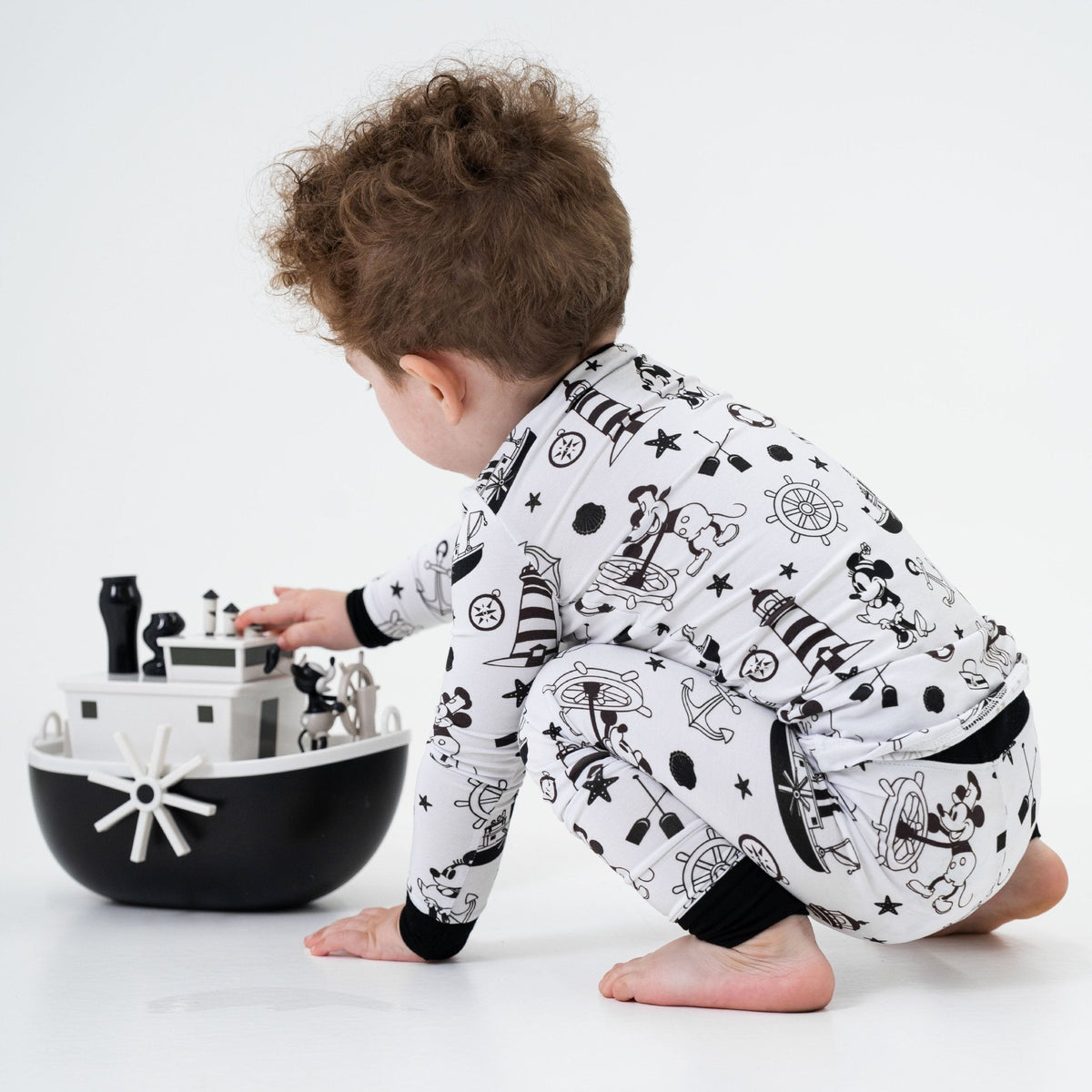 Child playing while wearing Bam & Stitch Steamboat Willie Long Sleeve Pajamas.