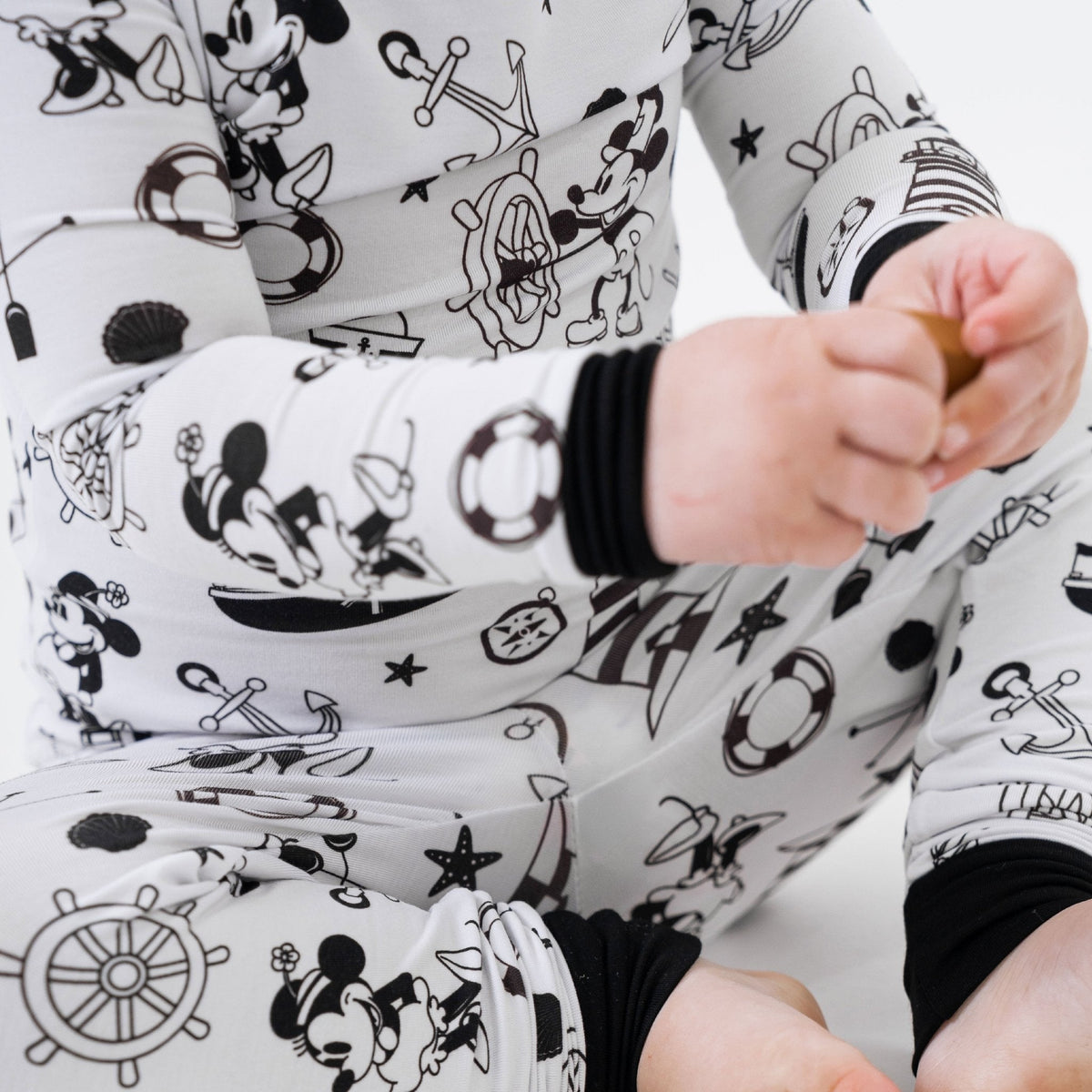 Close-up of the wrist cuff and fabric on Bam & Stitch Steamboat Willie Long Sleeve Pajamas.