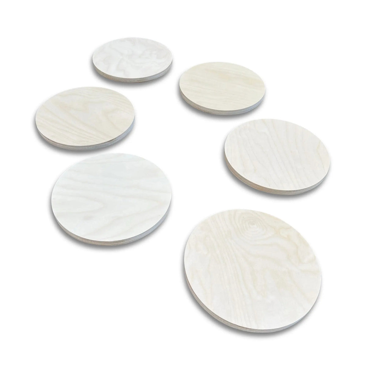 Six pale natural-tone round stepping stones with visible grain, arranged on white.