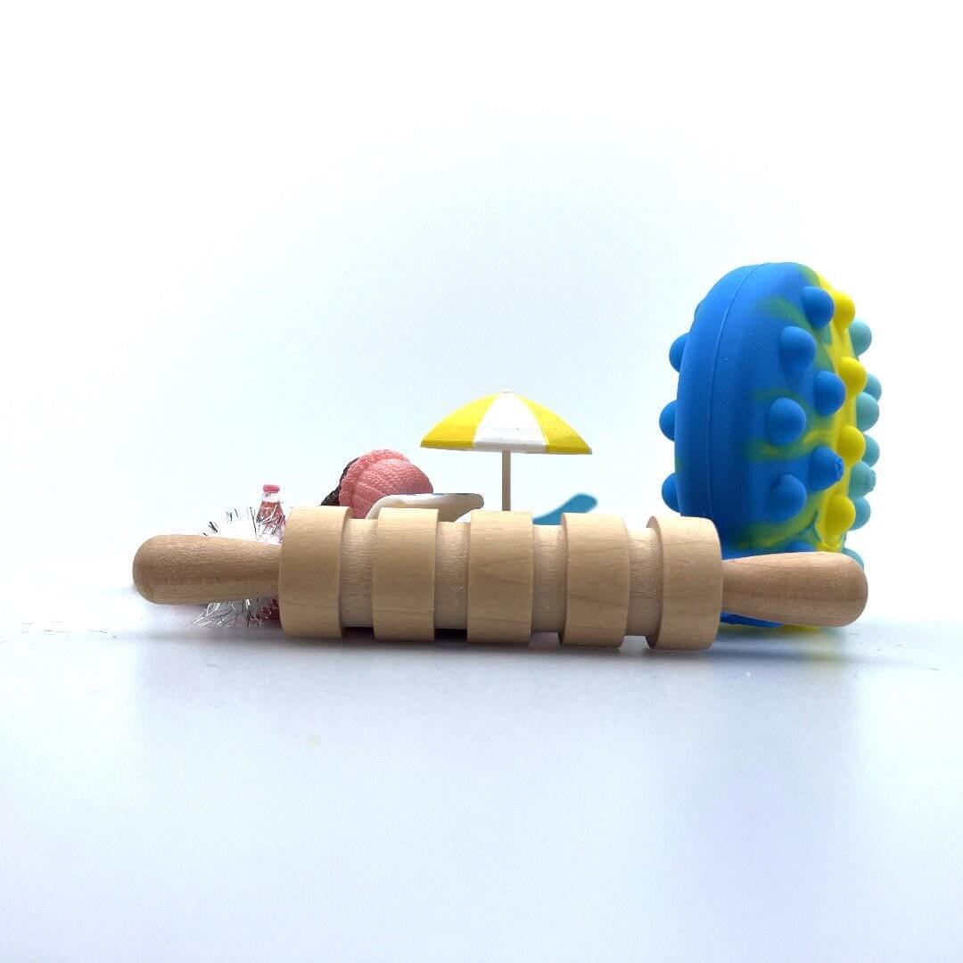 Grooved rolling pin in front of the Surf & Sand beach scene and sea-animal fidget
