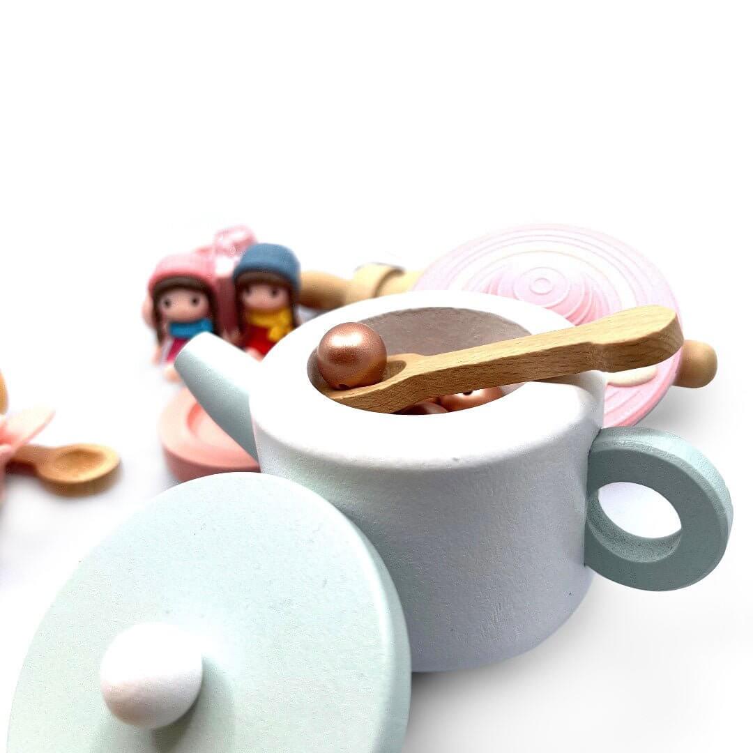Open toy teapot with spoon and brown beads; the pictured pink tea-party hat is not included