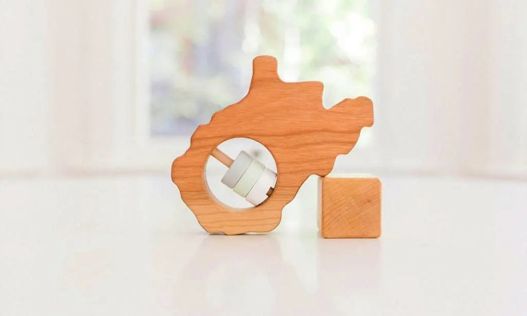 Bannor Toys West Virginia State Wooden Baby Rattle, showing state-shaped cherry-wood body and colored rattle discs