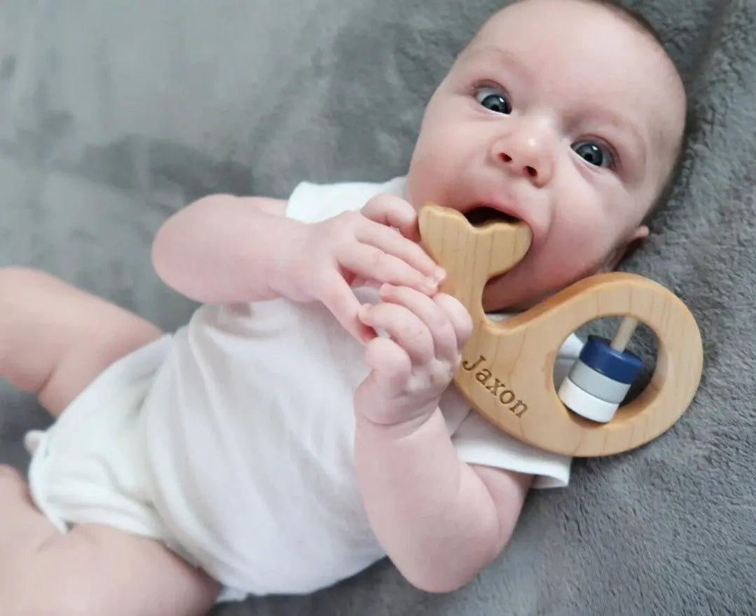 Lifestyle photo showing a wooden baby rattle with a child