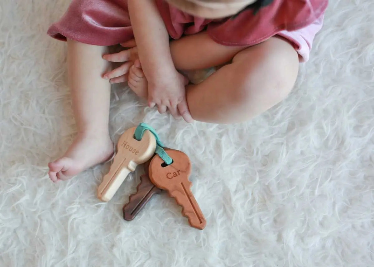 Lifestyle photo showing wooden toy keys with a child