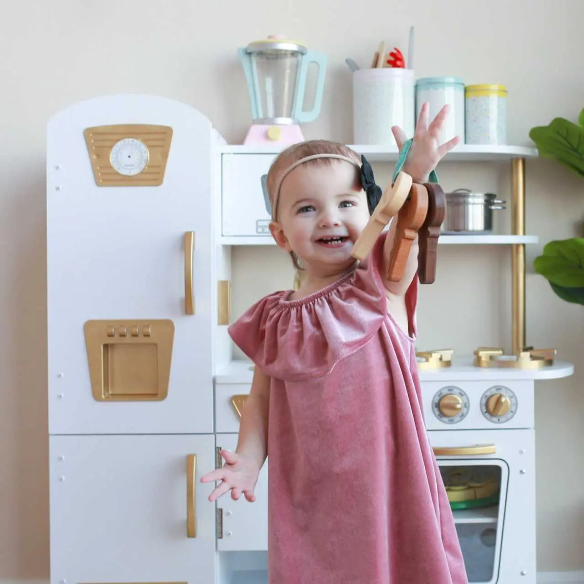 Lifestyle photo showing wooden toy keys with a child