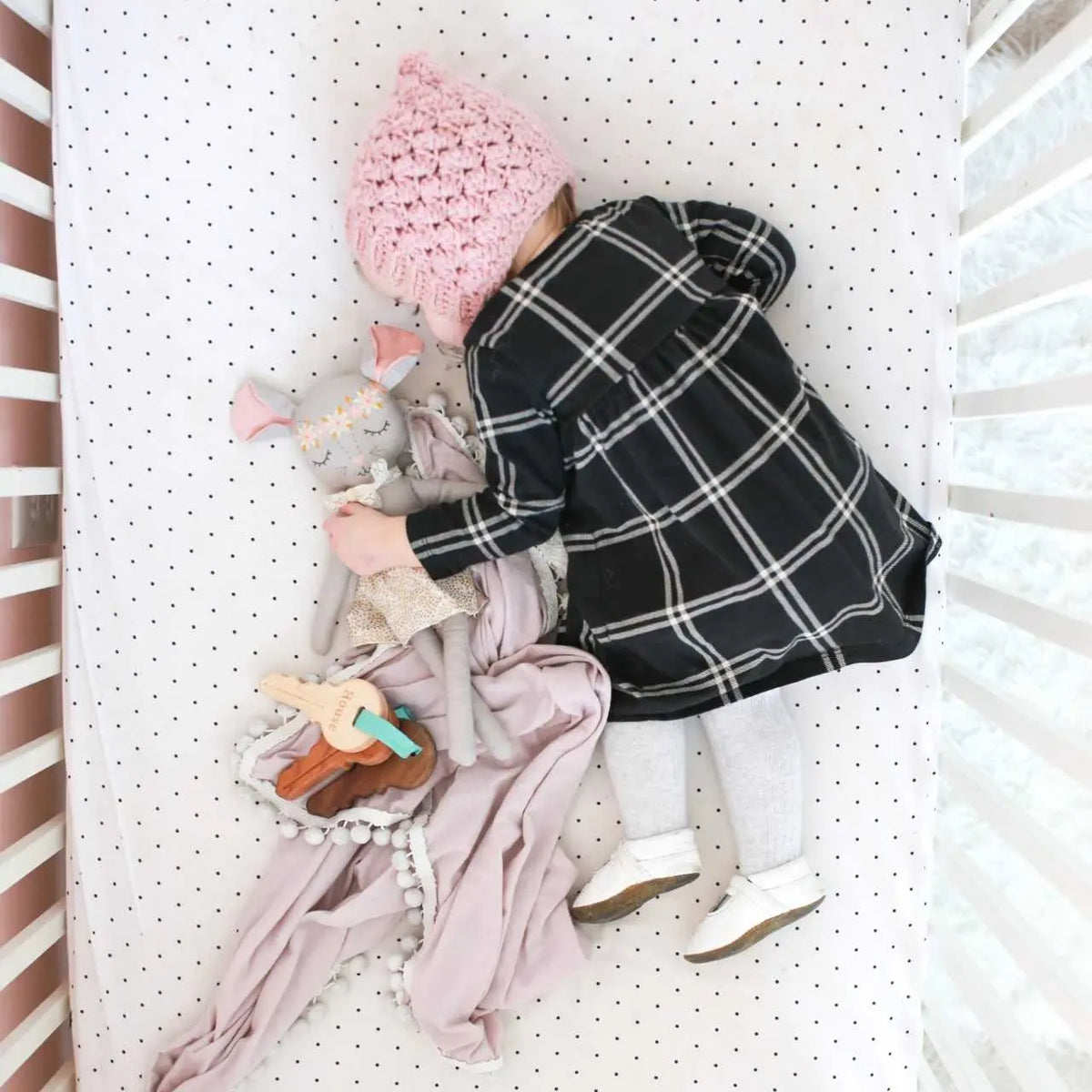 Lifestyle photo showing wooden toy keys with a child