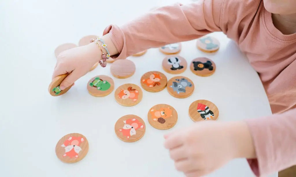 Lifestyle photo showing woodland animal matching tiles with a child