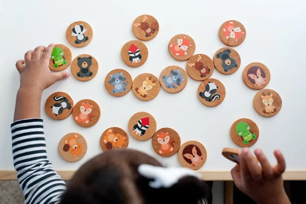 Lifestyle photo showing woodland animal matching tiles with a child