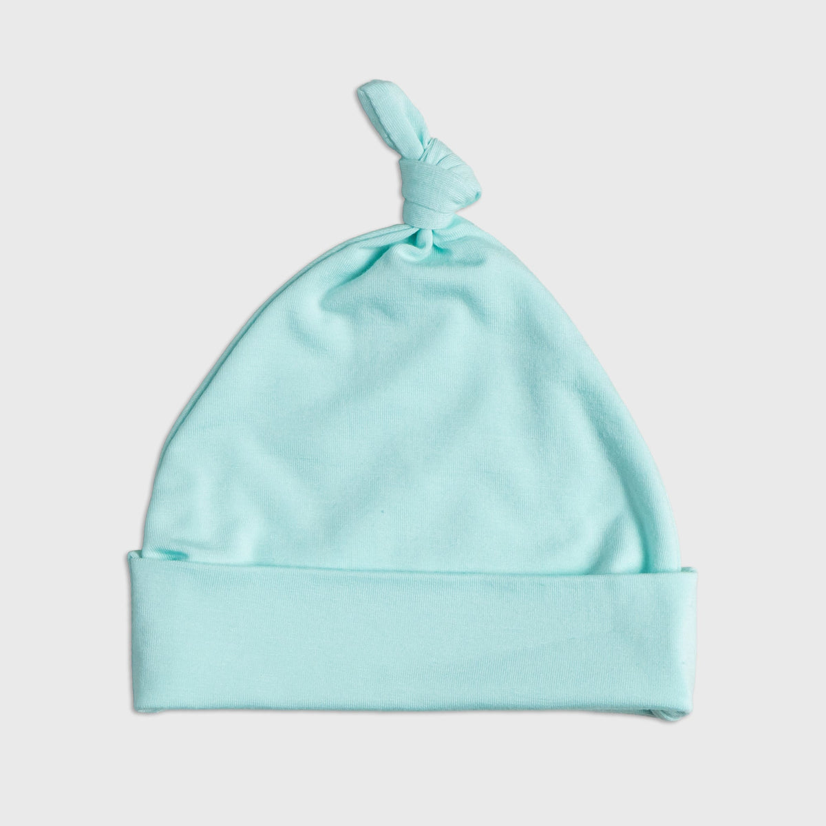 Flat lay of Bam & Stitch Ocean Breeze Hat, showing the top knot and folded brim.