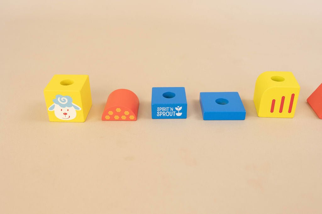 SpiritnSprout: Four individual farm-themed stacking blocks laid in a row