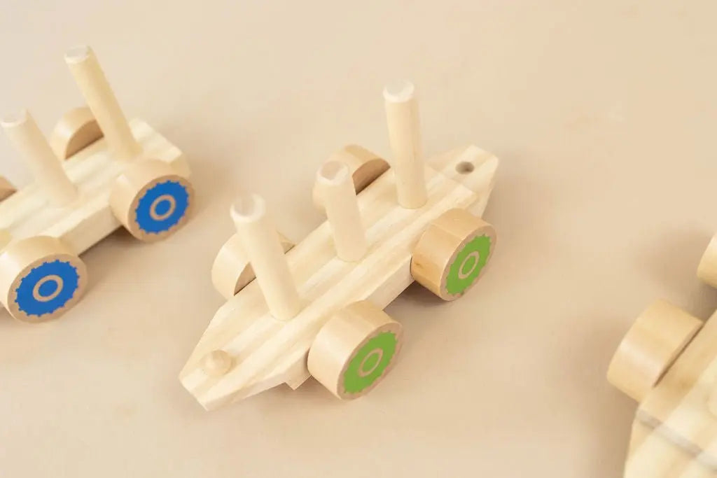 SpiritnSprout: Bare wooden train cars showing the vertical stacking pegs