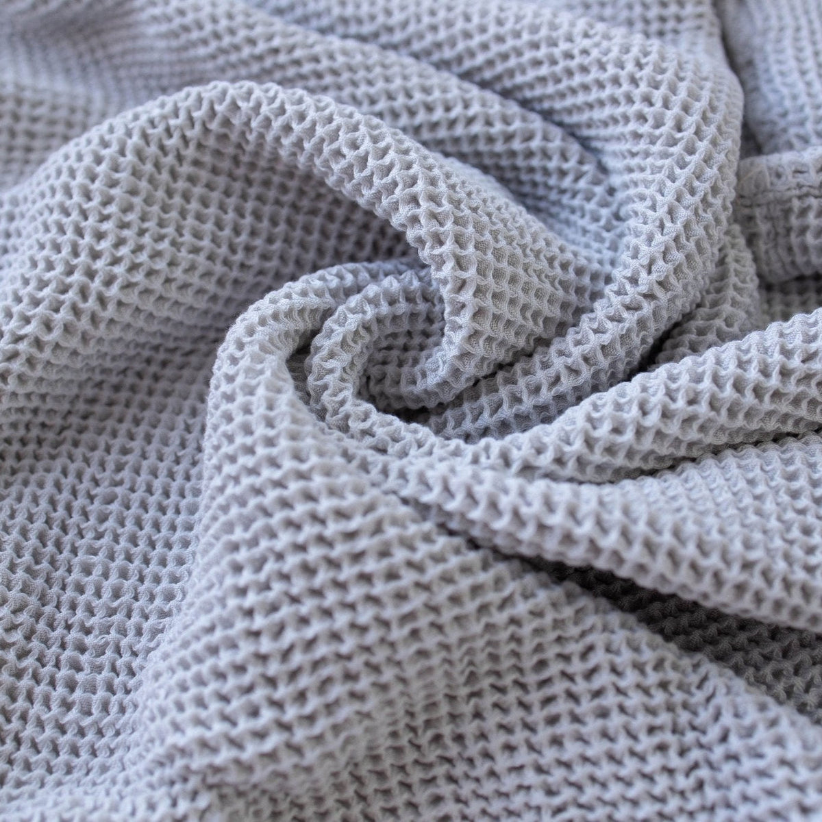 SpiritnSprout: Grey waffle blanket gathered to show its texture