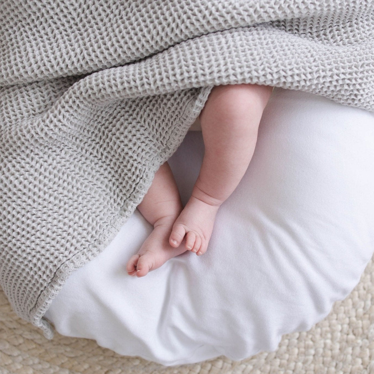 SpiritnSprout: Close-up of baby’s feet beside grey waffle fabric