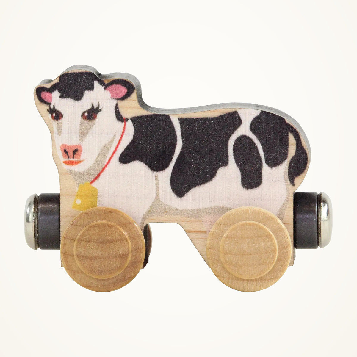 Maple Landmark NameTrains Clover the Cow photographed on a warm ivory background.
