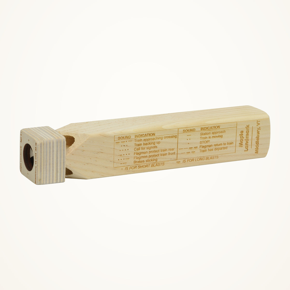 Maple Landmark Wooden Train Whistle with 11-Signal Blast Chart photographed on a warm ivory background.
