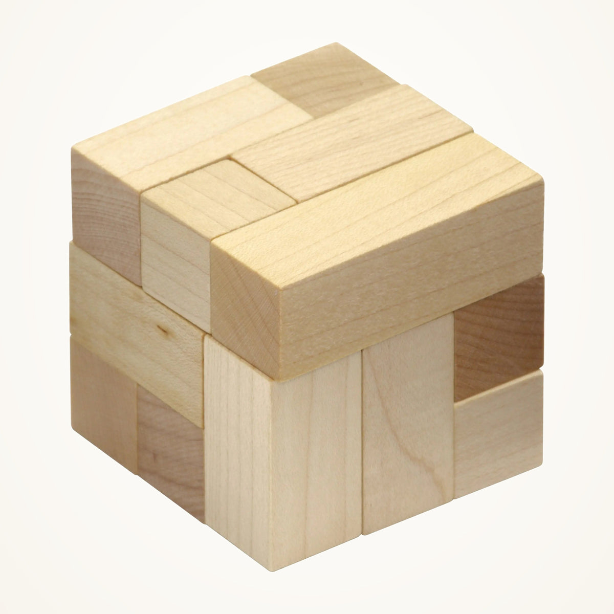 Maple Landmark Natural Wooden Soma Cube Puzzle photographed on a warm ivory background.