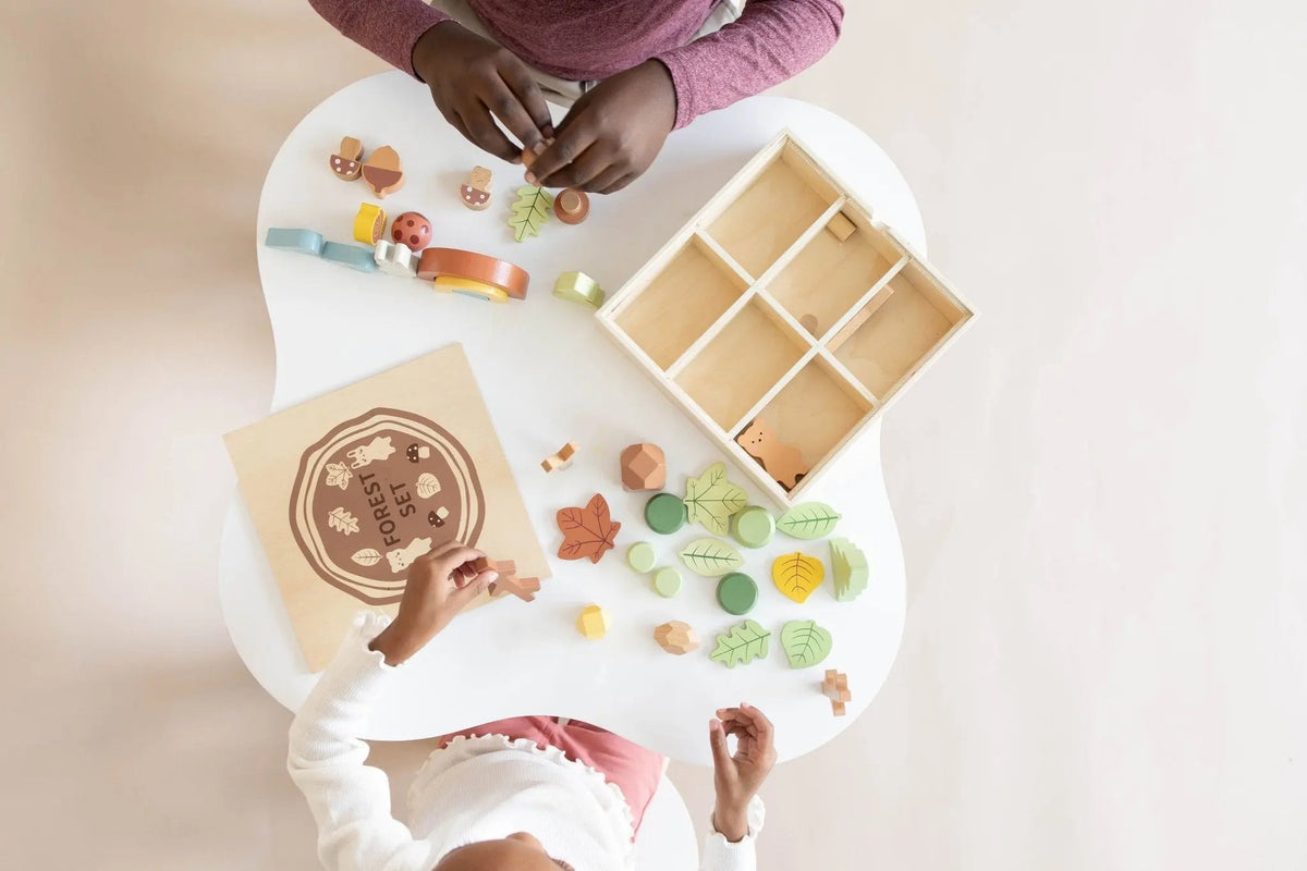 SpiritnSprout: Overhead view of children selecting pieces from the forest box