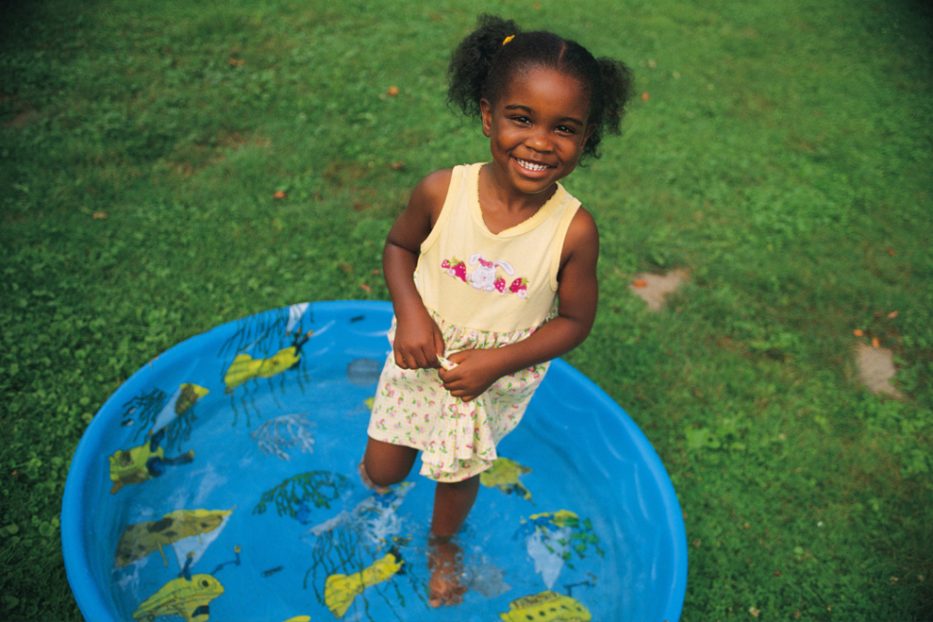 Playing in a kiddie pool on a hot summer day is a delightful experience for children. 